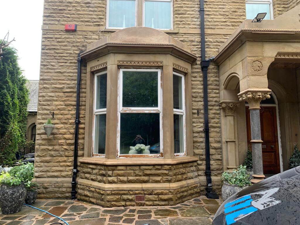 After image of outer bay window stripped back to limestone finish after sandblasting job.