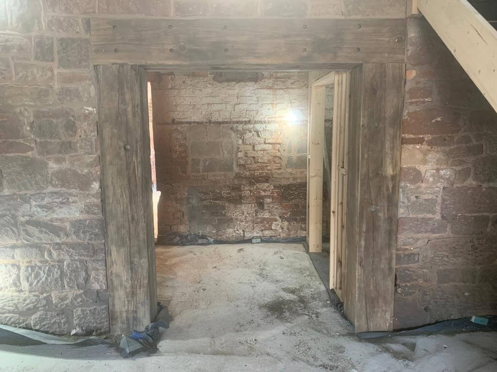 After image of stained and blackened wooden beams inside property now stripped back to bare wood and cleaned.