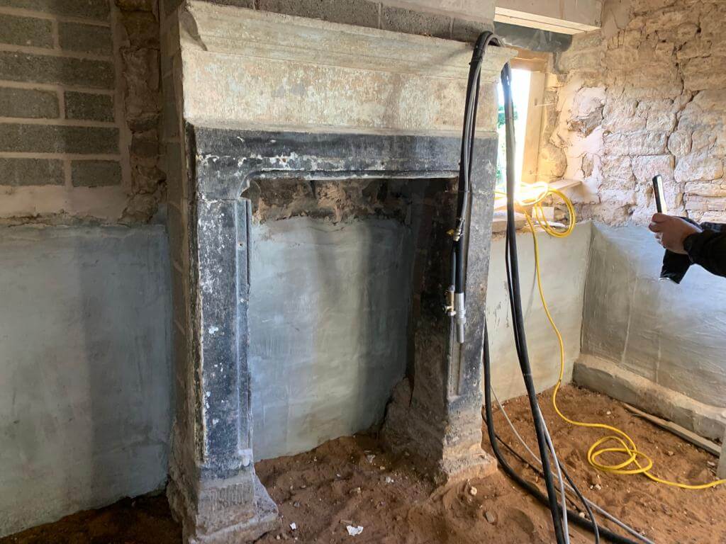 Before image of stained chimney breast.