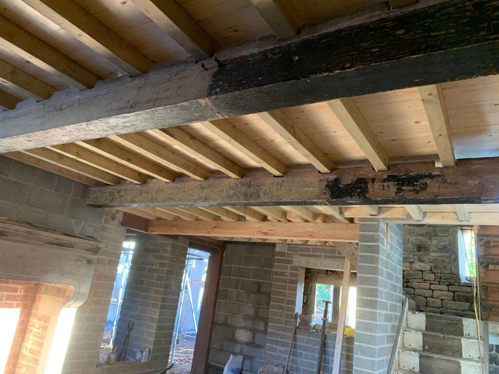 Before image of paint splattered wooden beams.