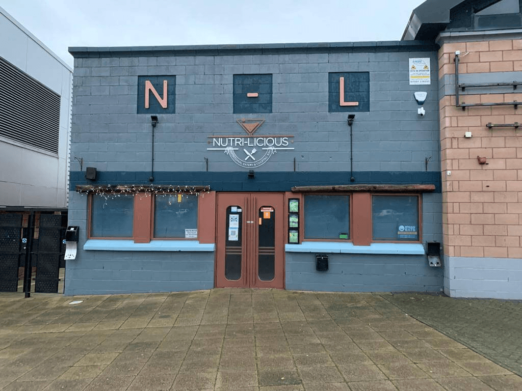 Before image of commercial building coated with old flaking paint.