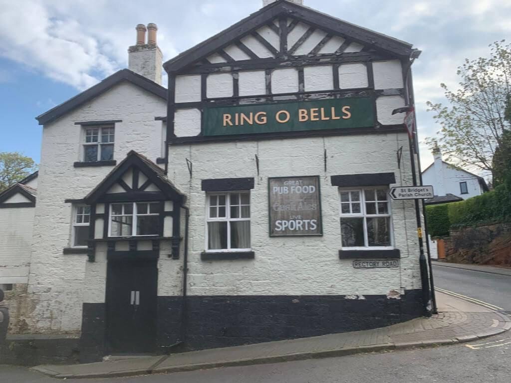 Before image of pub outer wall covered in old flaking white paint on Rectory Road.