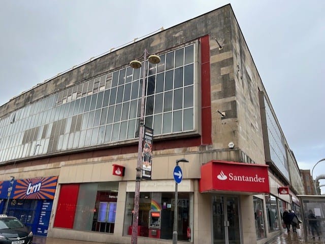 Close up corner angled before view of MBH shops in Blackpool town centre.