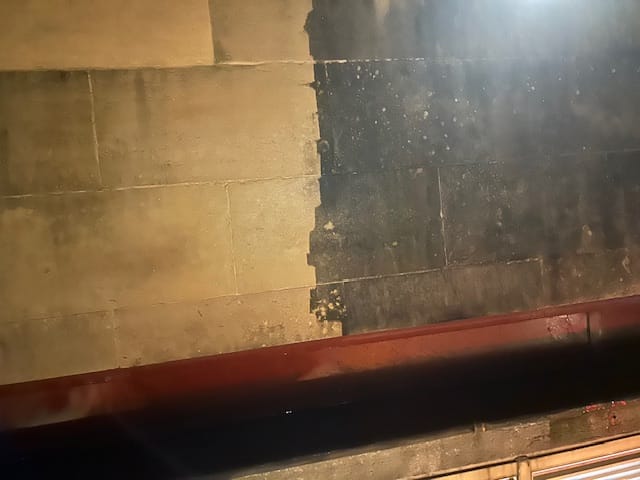 Job halfway through showing old dirty brickwork next to clean blasted brickwork.