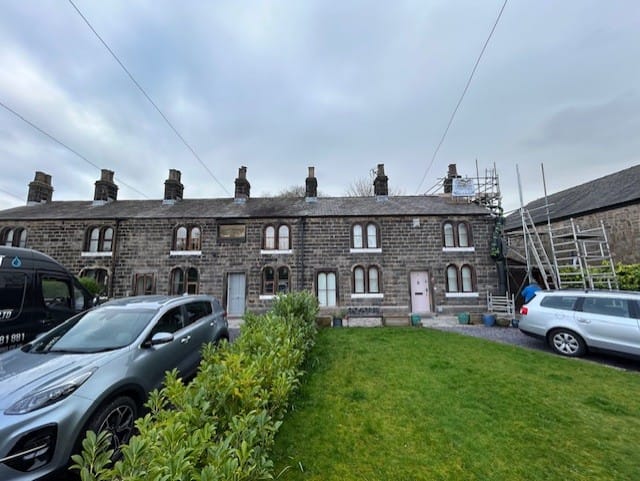 Front angled before photo showing Whittle cottages from roadside.