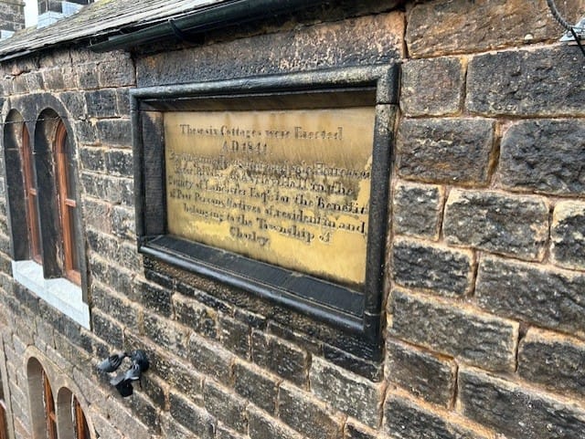 Close up before image of Whittle cottages sign.